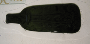 fused bottle with kiln carving